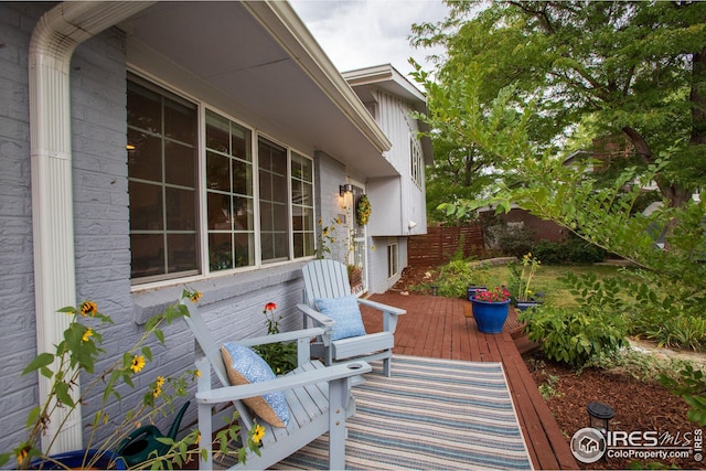 view of patio / terrace featuring a deck and fence