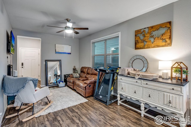 interior space with a ceiling fan and wood finished floors