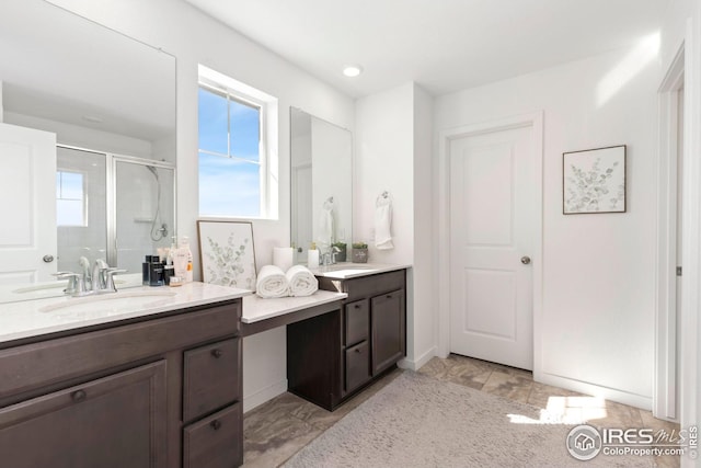 full bathroom with a shower stall, a healthy amount of sunlight, and vanity