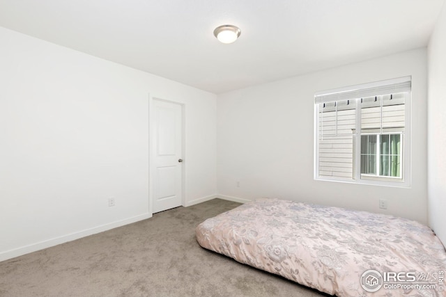 bedroom with carpet and baseboards