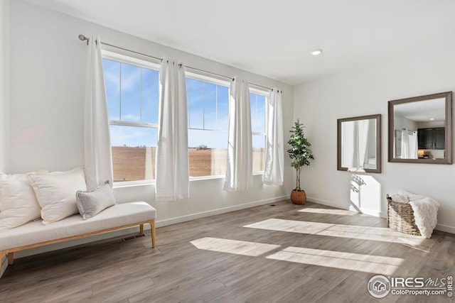 sitting room with baseboards, wood finished floors, visible vents, and recessed lighting