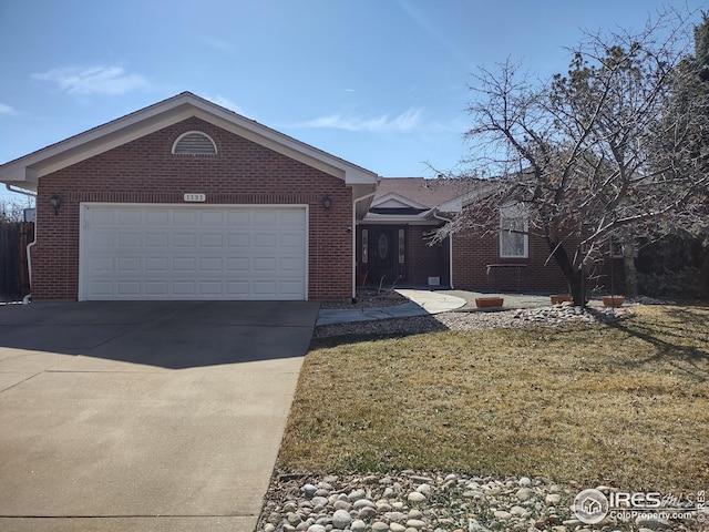 ranch-style home with a garage, brick siding, driveway, and a front lawn