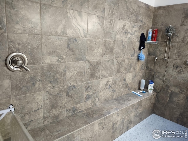 full bath featuring a tile shower