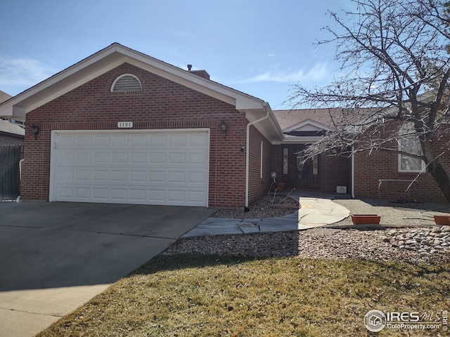 view of property exterior featuring a garage, concrete driveway, and brick siding