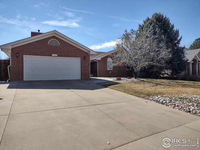 single story home featuring driveway, brick siding, and an attached garage