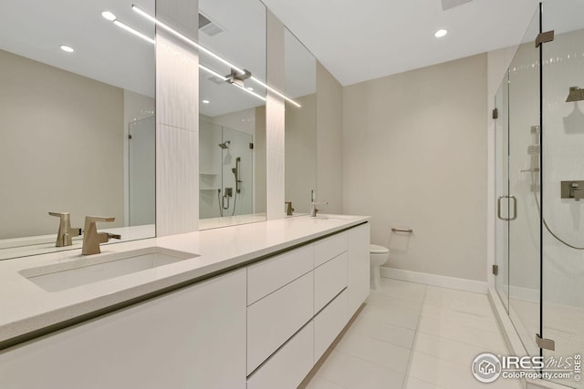 bathroom featuring double vanity, a stall shower, visible vents, toilet, and a sink