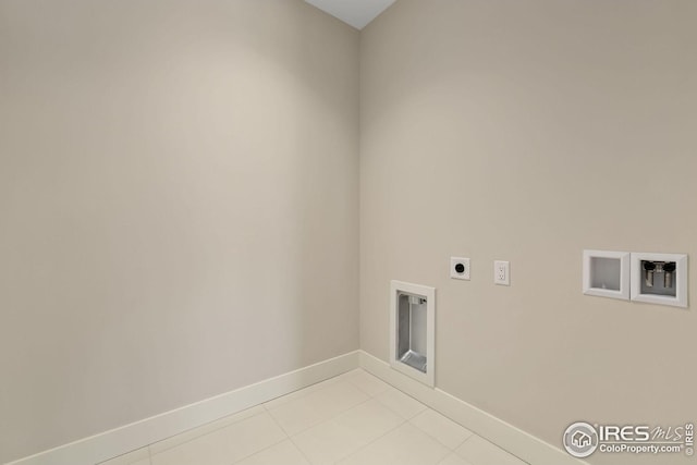 washroom with washer hookup, light tile patterned floors, electric dryer hookup, laundry area, and baseboards