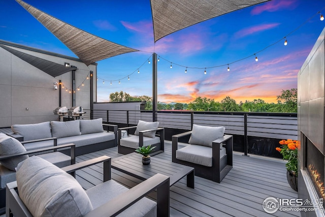 deck at dusk featuring an outdoor living space