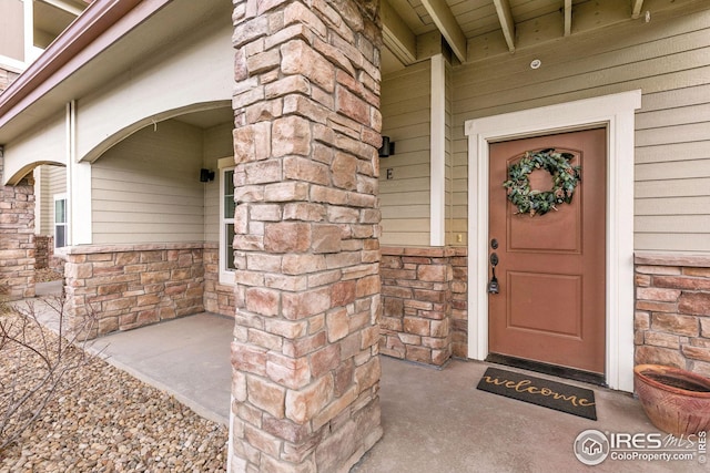 property entrance with stone siding