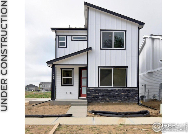 view of front of property with stone siding and board and batten siding