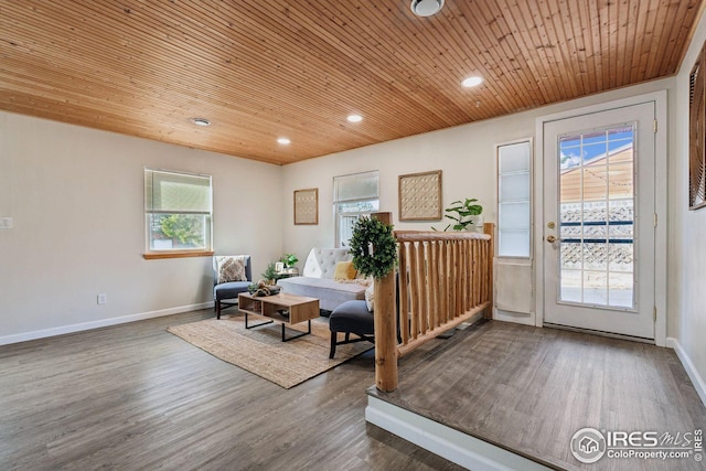 living area with recessed lighting, wood ceiling, baseboards, and wood finished floors