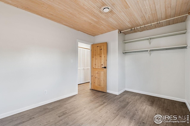 unfurnished bedroom with wooden ceiling, wood finished floors, and baseboards