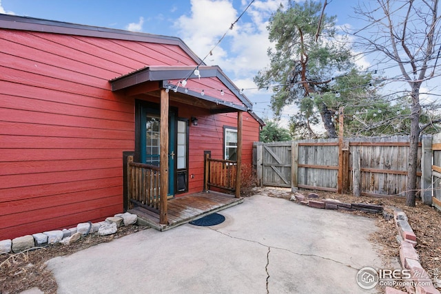 view of patio with fence and a gate