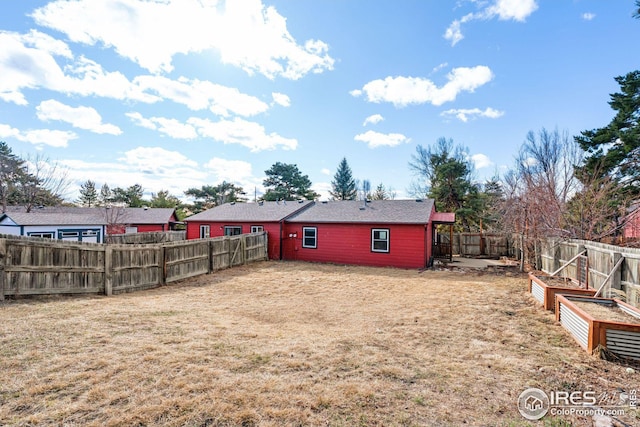 view of yard with a garden and a fenced backyard