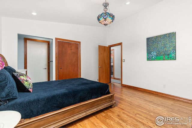 bedroom featuring recessed lighting, light wood-type flooring, and baseboards