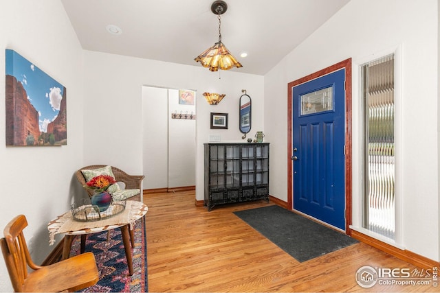 foyer entrance with light wood-type flooring and baseboards