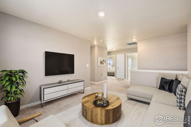 living room featuring carpet floors, visible vents, and baseboards