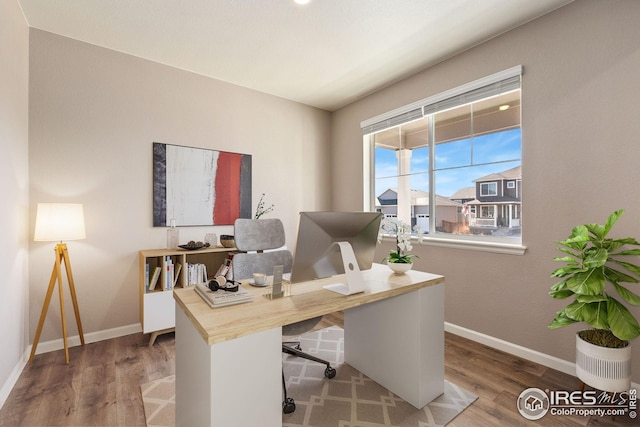 office area with wood finished floors and baseboards