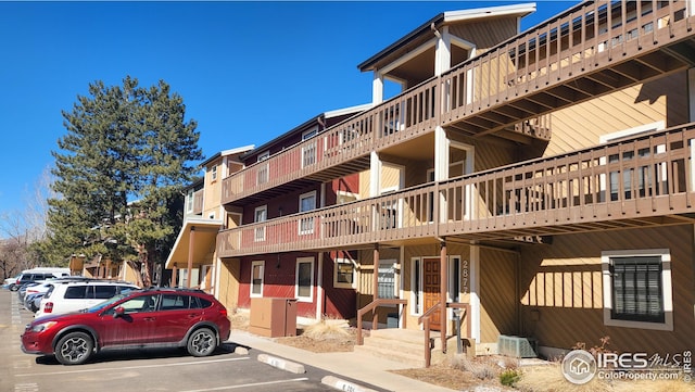 view of building exterior with uncovered parking