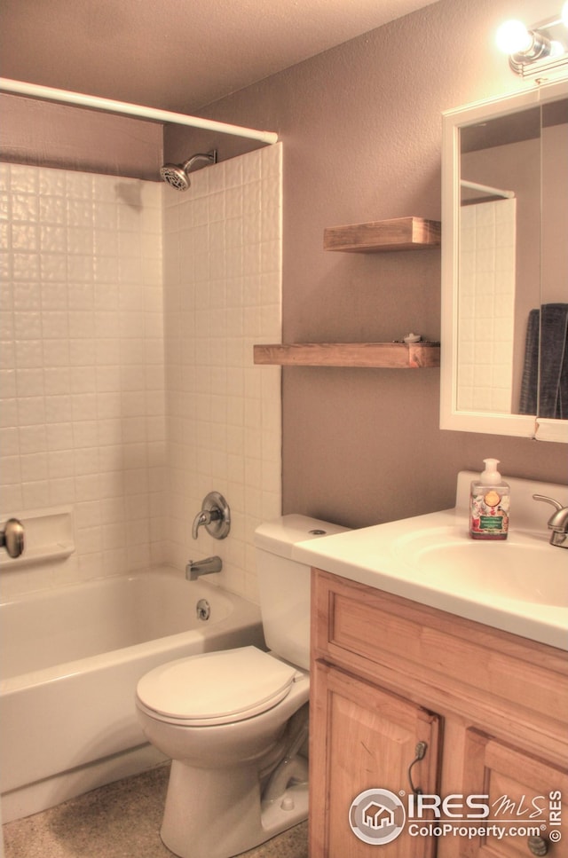 bathroom featuring toilet, shower / bathing tub combination, and vanity