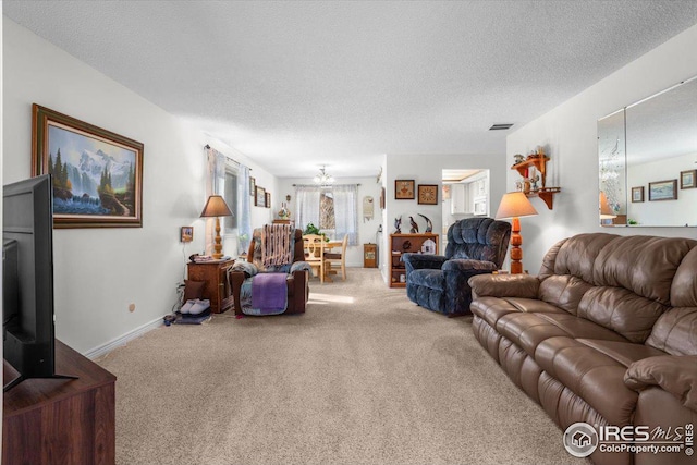 carpeted living area with baseboards, visible vents, and a textured ceiling