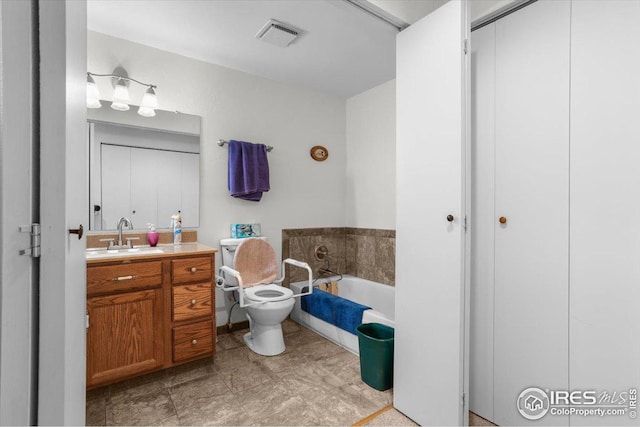 bathroom with visible vents, vanity, toilet, and a bath