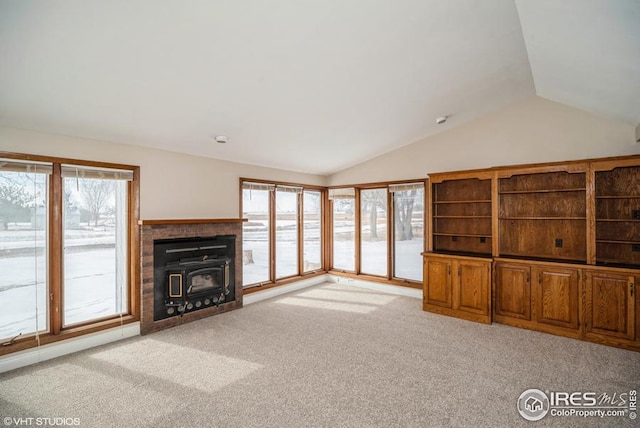 unfurnished living room featuring lofted ceiling and light colored carpet