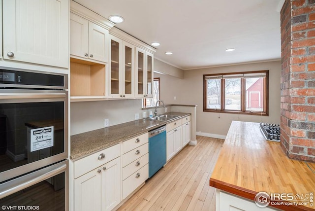 kitchen with wooden counters, double oven, glass insert cabinets, a sink, and dishwasher