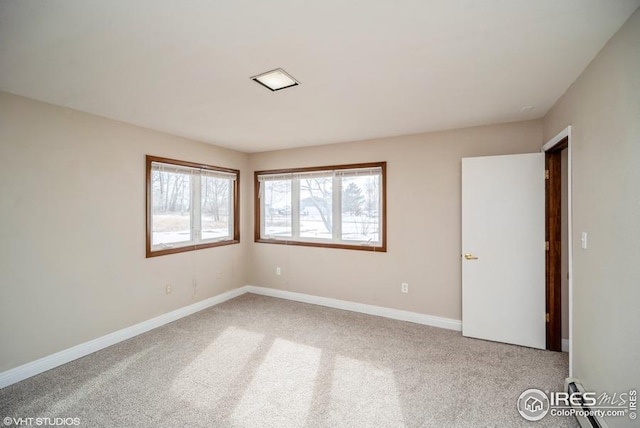 empty room featuring carpet floors and baseboards