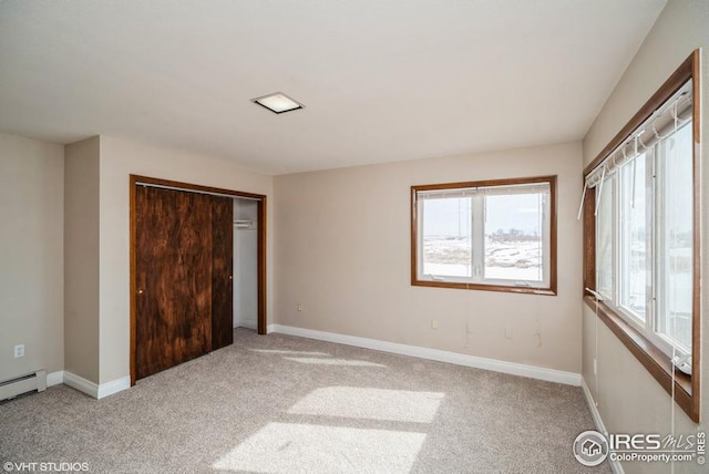 unfurnished bedroom with carpet, baseboards, and a closet