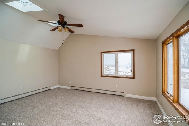 bonus room with a baseboard heating unit, vaulted ceiling with skylight, and carpet flooring