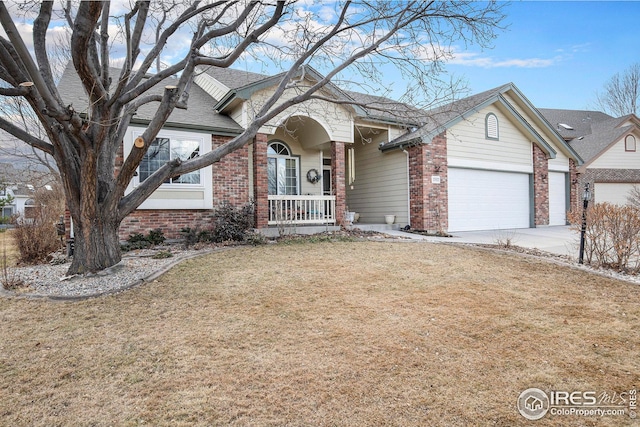 view of front of property featuring brick siding, concrete driveway, an attached garage, a porch, and a front yard