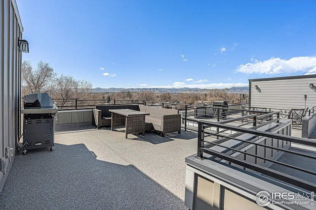 view of patio with a grill and a mountain view