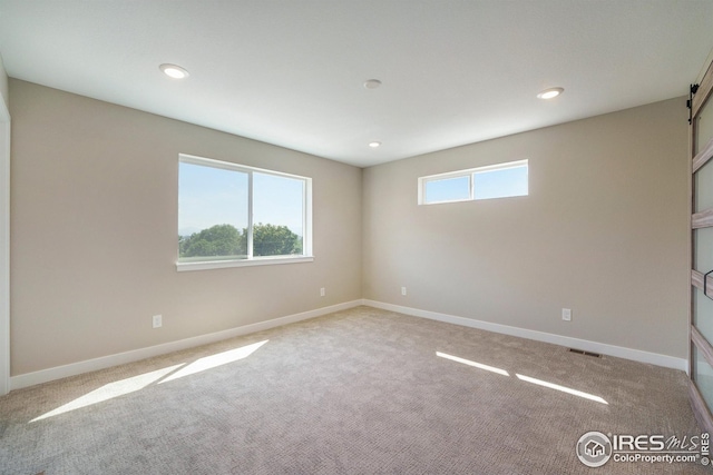spare room with a healthy amount of sunlight, baseboards, and recessed lighting