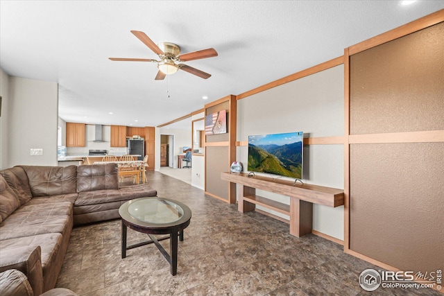 living area featuring recessed lighting, ceiling fan, and baseboards