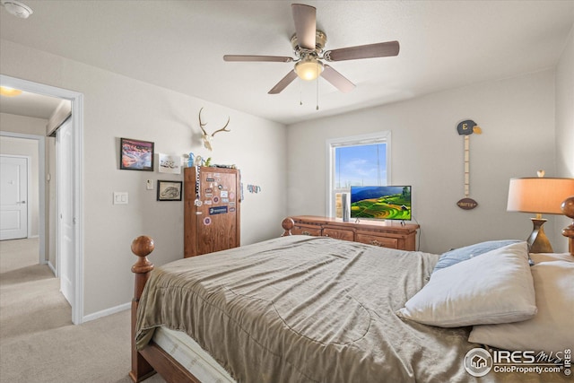 carpeted bedroom with a ceiling fan and baseboards