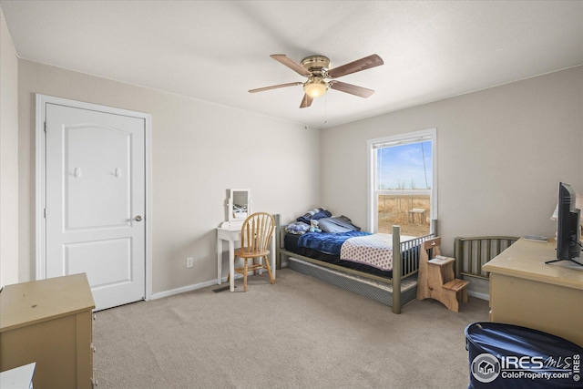 bedroom with light carpet, baseboards, and a ceiling fan