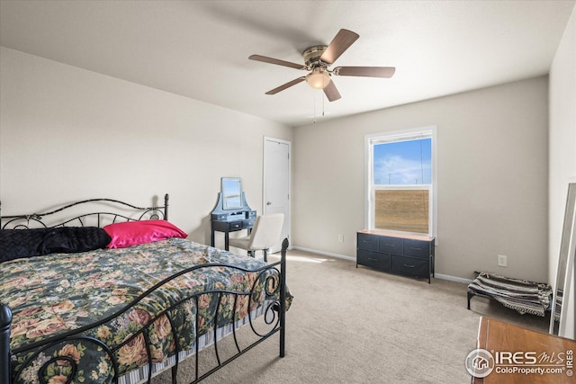 bedroom with baseboards, ceiling fan, and light colored carpet