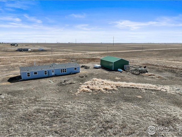 birds eye view of property with a rural view