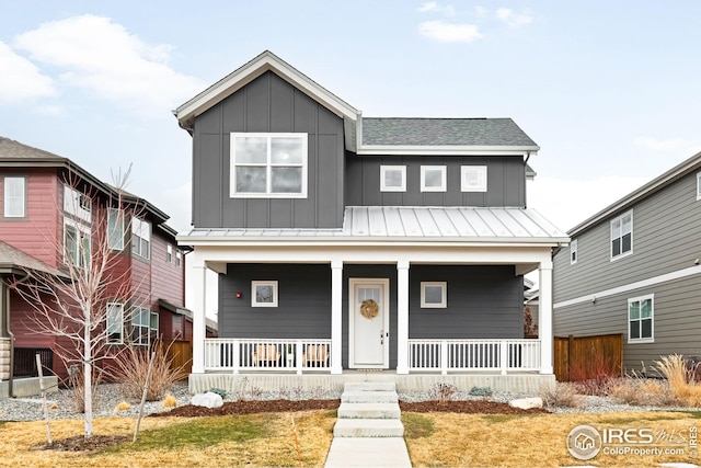 view of front of home featuring covered porch, a shingled roof, and board and batten siding