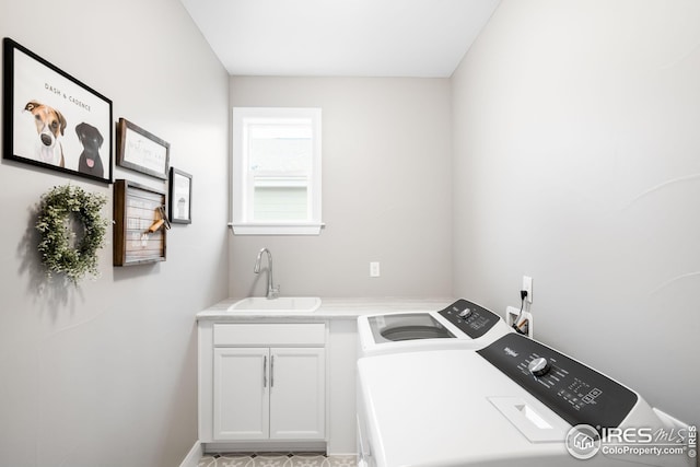 laundry room featuring a sink, cabinet space, and separate washer and dryer