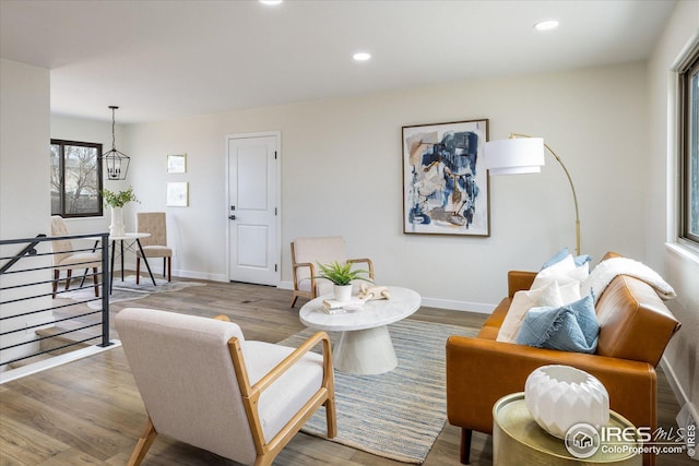 living area featuring recessed lighting, baseboards, and wood finished floors