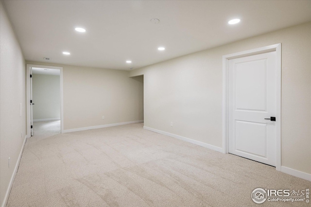 below grade area featuring baseboards, carpet flooring, and recessed lighting