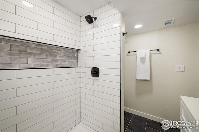 bathroom featuring baseboards, visible vents, tile patterned flooring, a tile shower, and recessed lighting