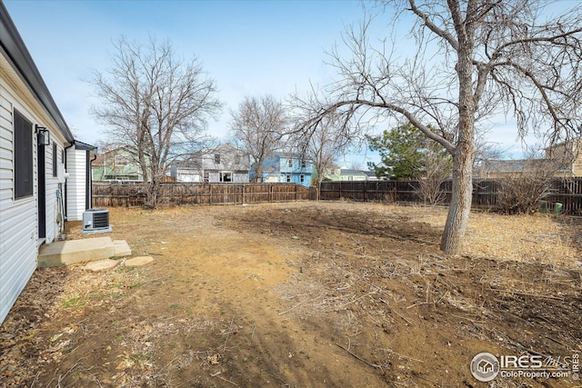 view of yard featuring a fenced backyard and central AC unit