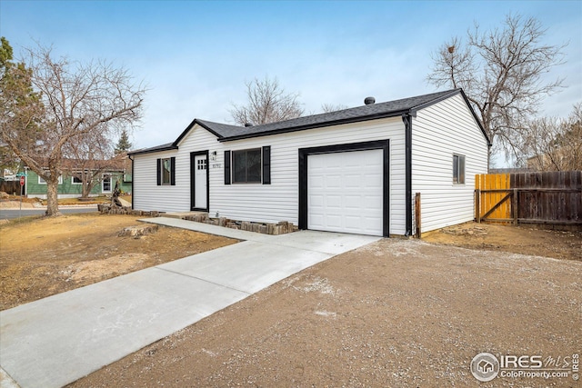 ranch-style home with driveway, an attached garage, and fence