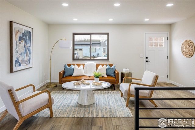 living room with baseboards, wood finished floors, and recessed lighting