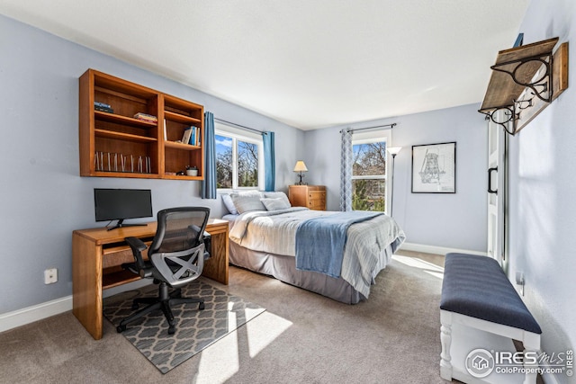 carpeted bedroom with baseboards