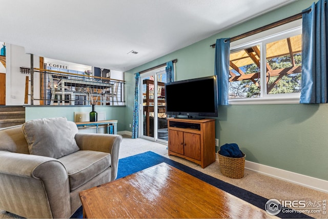 living area featuring visible vents, a bar, stairs, and baseboards