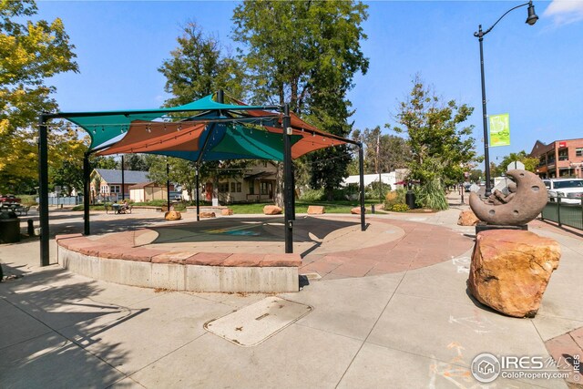 view of street featuring curbs, traffic signs, street lighting, and sidewalks